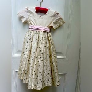 Girls size 6 silk dress. Cream with pink flowers and bow. Excellent condition.